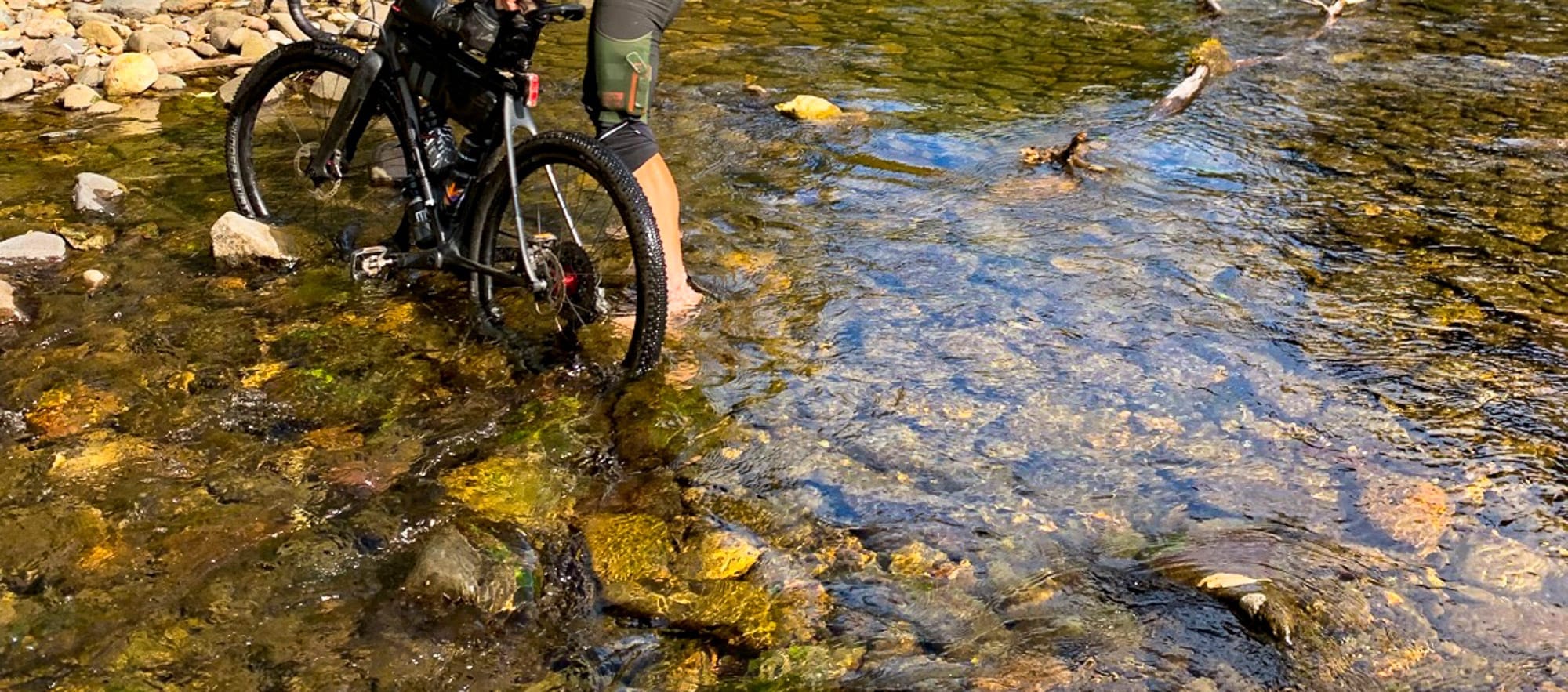 wading across a stream with my bicycle
