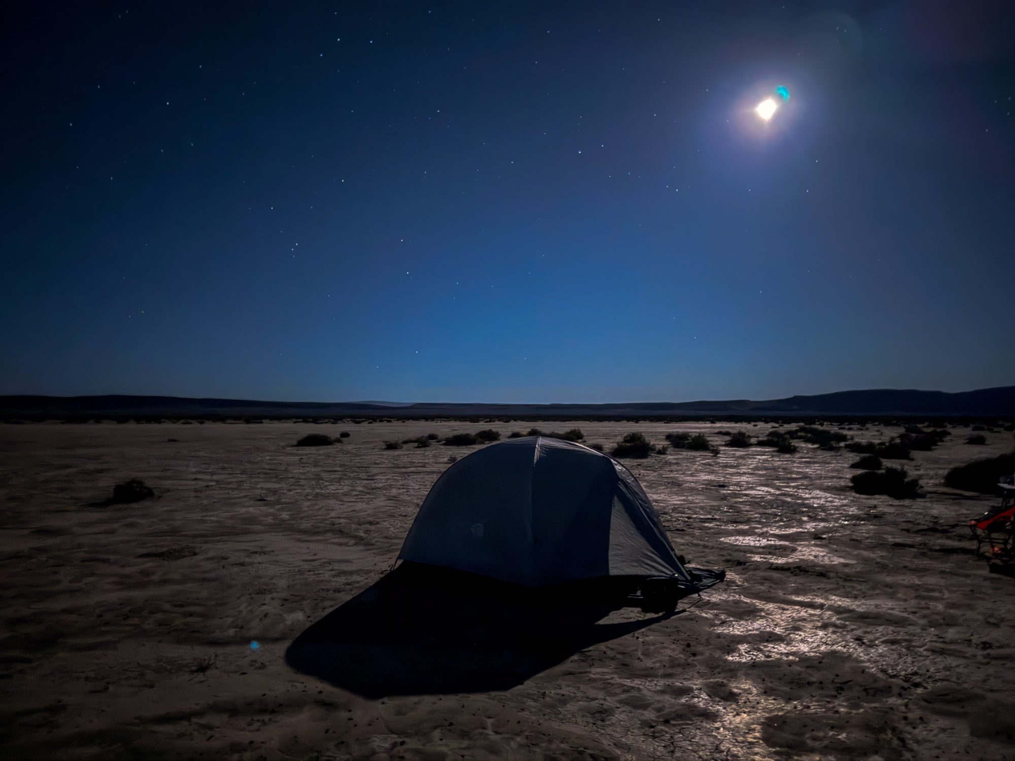 Tent on the moonlit Alvord Playa at 3am, stars above