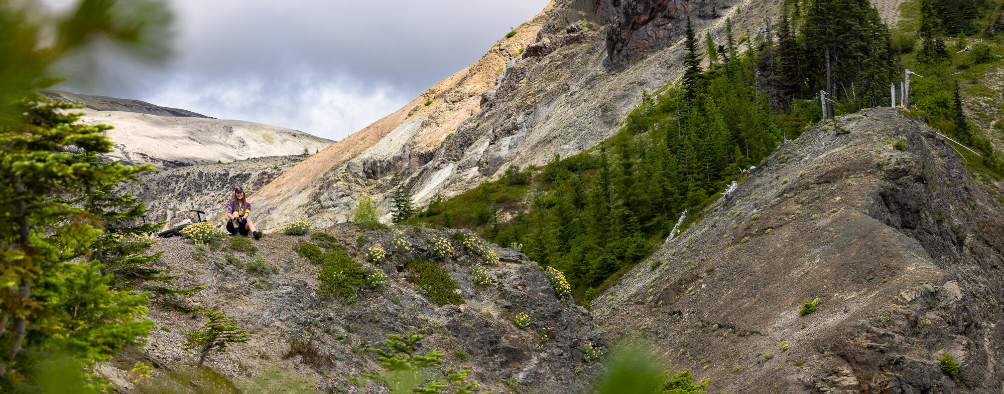 Panorama of the raw eroded gorge of Ape Canyon with a rider on the rim
